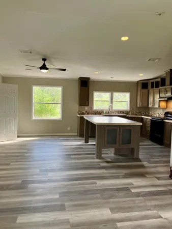 a kitchen with stainless steel appliances kitchen island a stove and a wooden cabinets