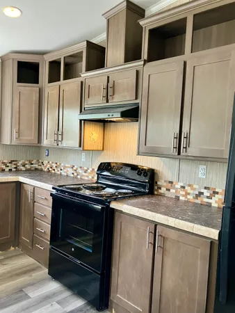 a kitchen with stainless steel appliances granite countertop a stove and a microwave