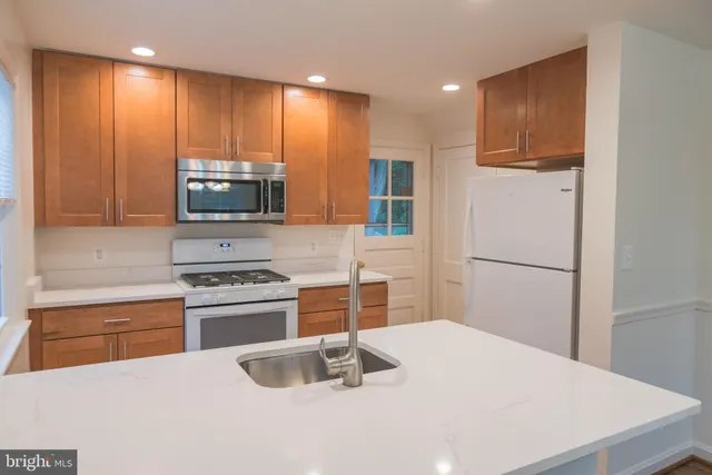 a kitchen with granite countertop cabinets stainless steel appliances and a sink