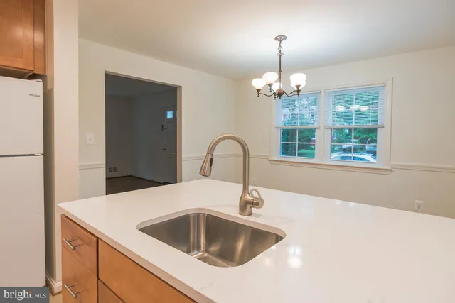 a kitchen with stainless steel appliances granite countertop a sink a stove a refrigerator a microwave oven with wooden floor and cabinets