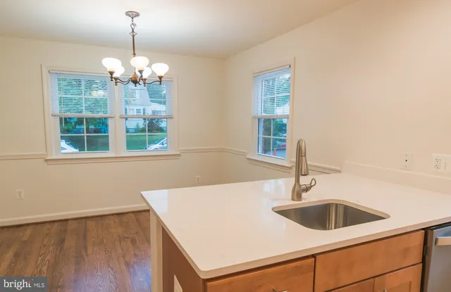 a view of a room with wooden floor and large windows
