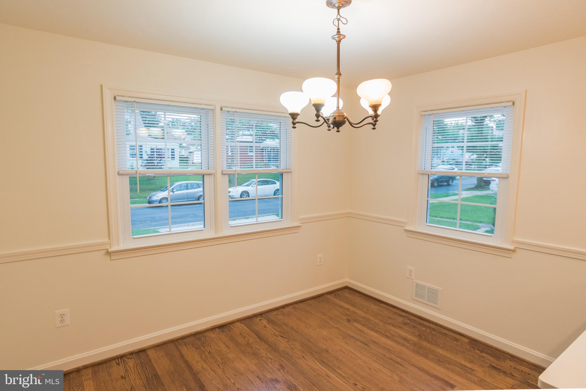 1613 Neely Road Silver Spring, MD 20903 - Photo 22 of 53 a view of an empty room with wooden floor and a window
