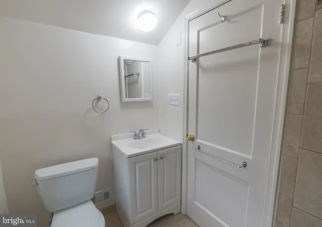 a view of a room with wooden floor and a window