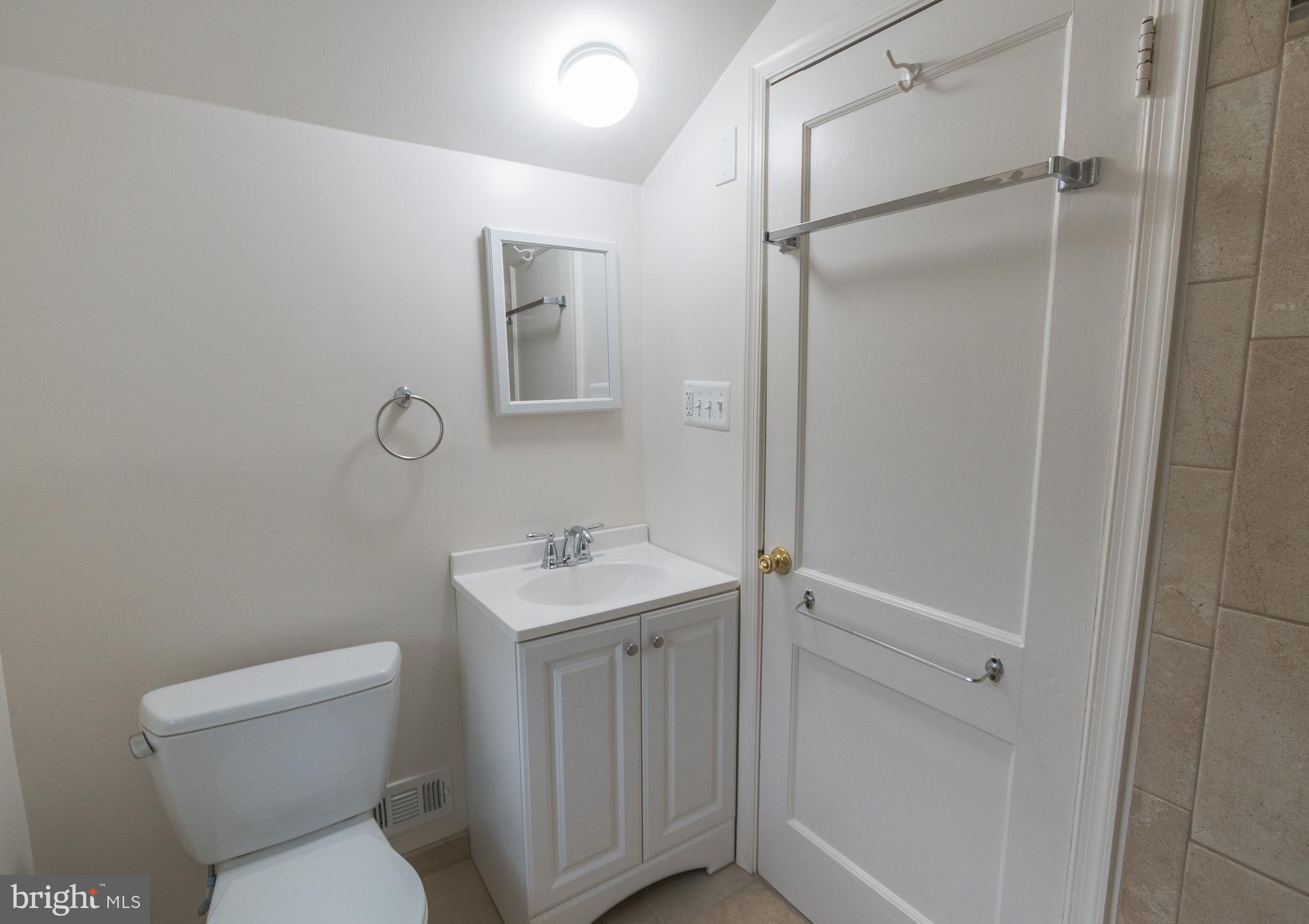 1613 Neely Road Silver Spring, MD 20903 - Photo 24 of 53 a bathroom with a toilet sink and shower