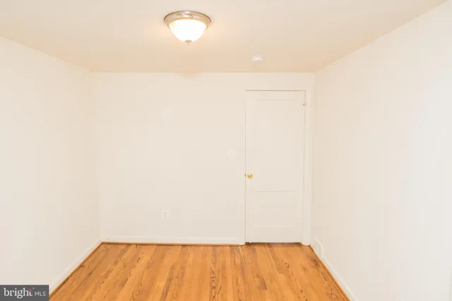 a view of a room with wooden floor and white walls
