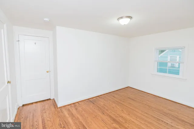 a view of a room with wooden floor and windows