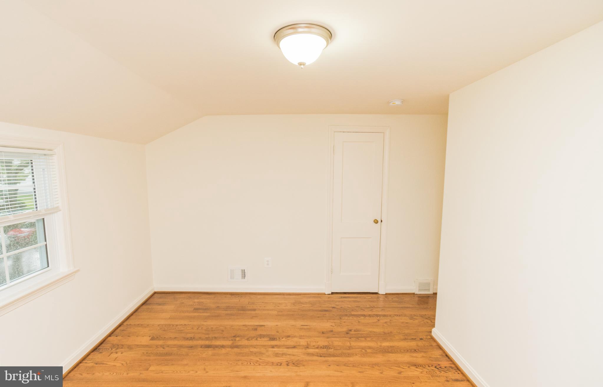 1613 Neely Road Silver Spring, MD 20903 - Photo 33 of 53 a view of a room with wooden floor and windows