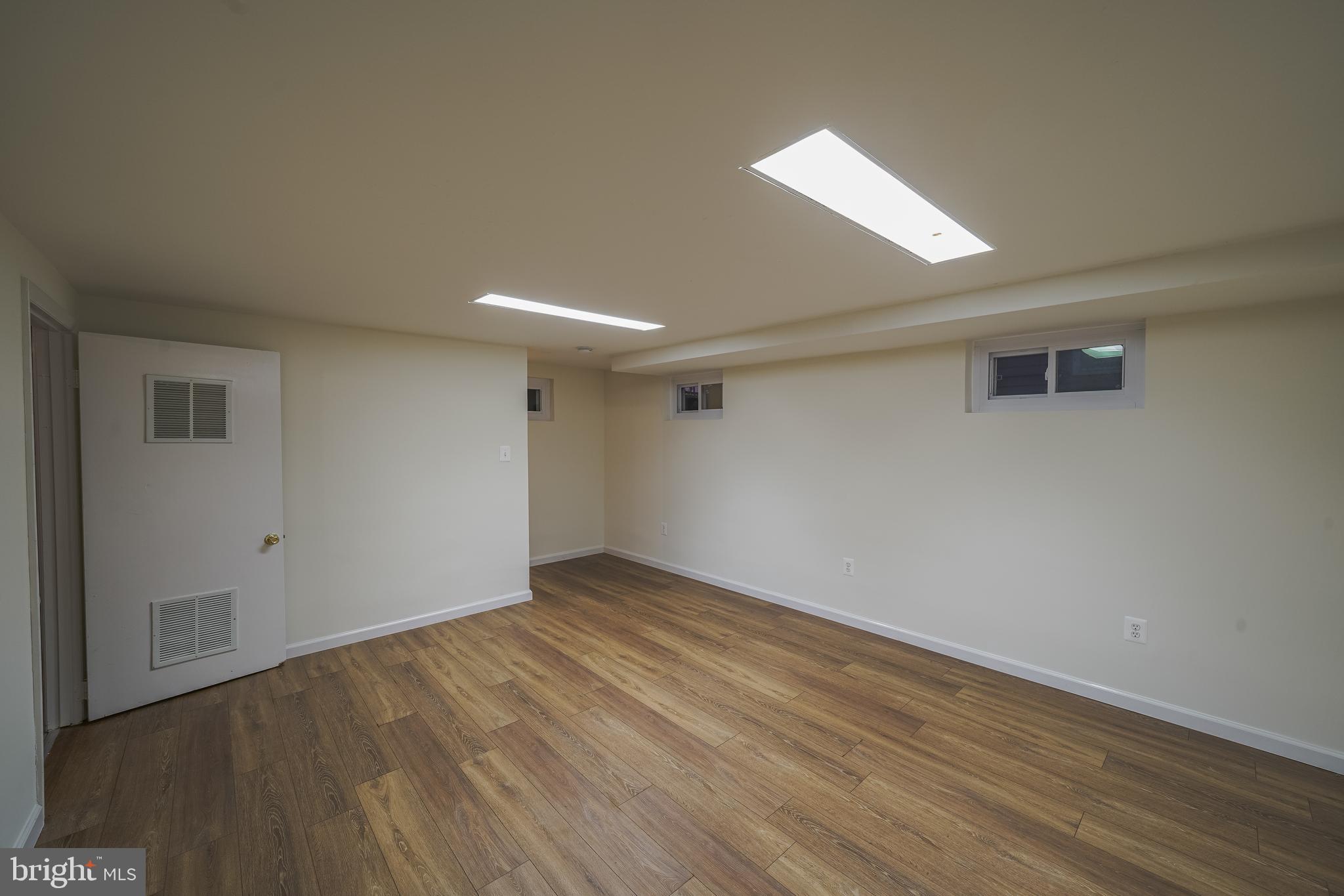 1613 Neely Road Silver Spring, MD 20903 - Photo 42 of 53 a view of an empty room with wooden floor and a window