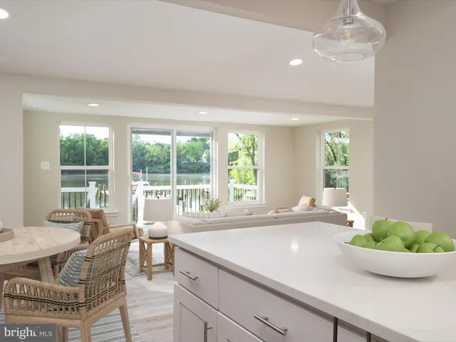 a living room with furniture and floor to ceiling windows