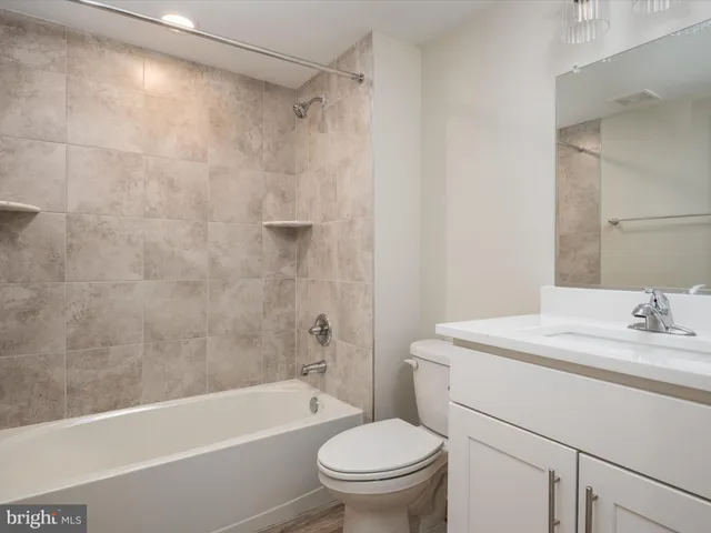 a bedroom with a bed and a painting