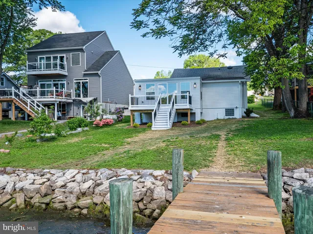 an aerial view of a house with a yard and lake view