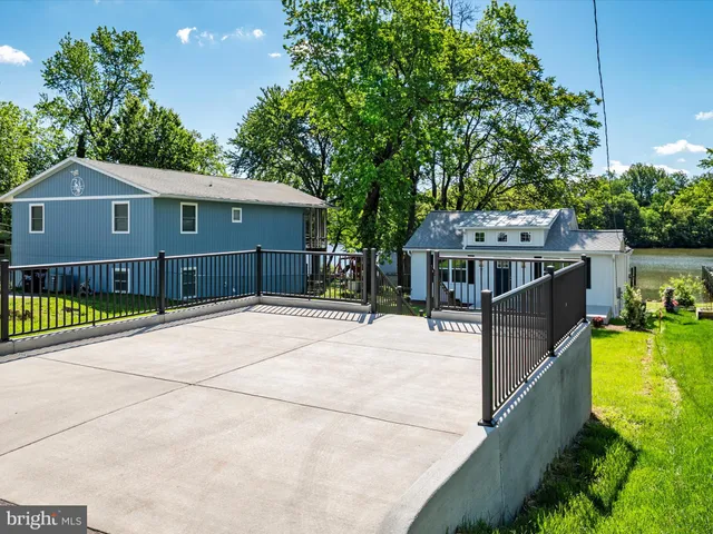 an aerial view of residential house with outdoor space and lake view