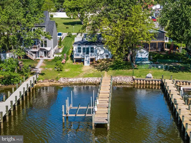 a view of house with yard and outdoor seating