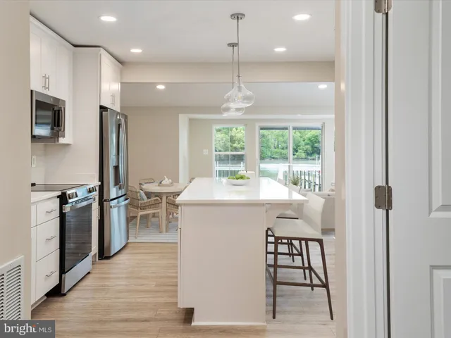 a kitchen with stainless steel appliances a refrigerator sink and microwave
