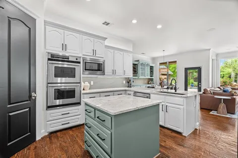 a kitchen with a sink stove and refrigerator