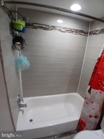 a bathroom with a granite countertop toilet sink and mirror