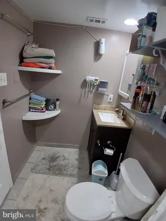 a bathroom with a toilet a sink and mirror