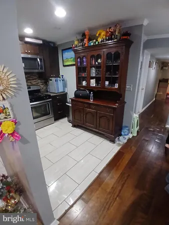 a kitchen with stainless steel appliances kitchen island granite countertop a refrigerator and a stove