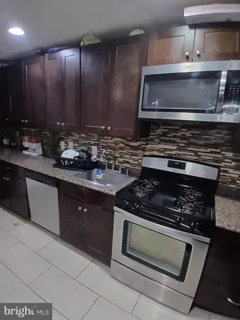 a kitchen with a stove and a sink