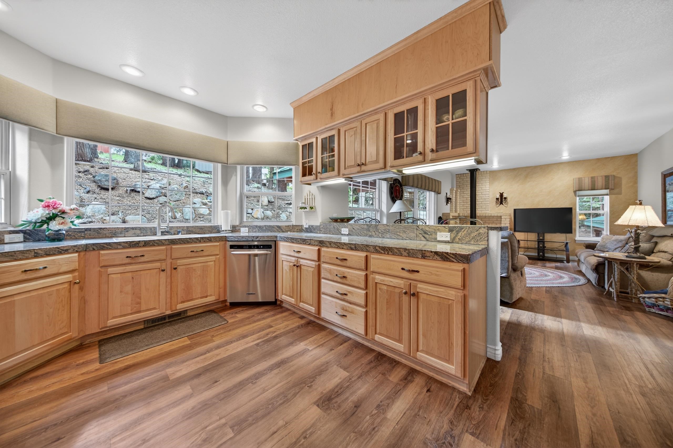 1017 Timber Ridge Road Lake Almanor, CA 96137 - Photo 12 of 45 a kitchen with stainless steel appliances granite countertop wooden floors and view living room