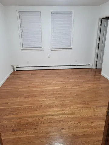 an empty room with wooden floor
