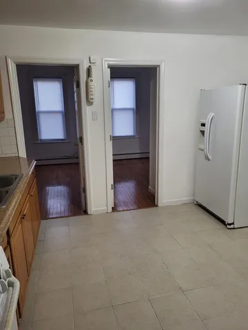 a view of a room with a refrigerator