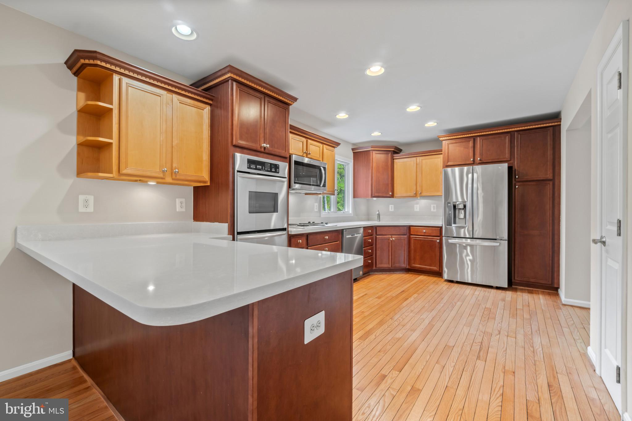 1609 Turkey Point Road Essex, MD 21221 - Photo 11 of 41 a kitchen with stainless steel appliances granite countertop a sink refrigerator and cabinets