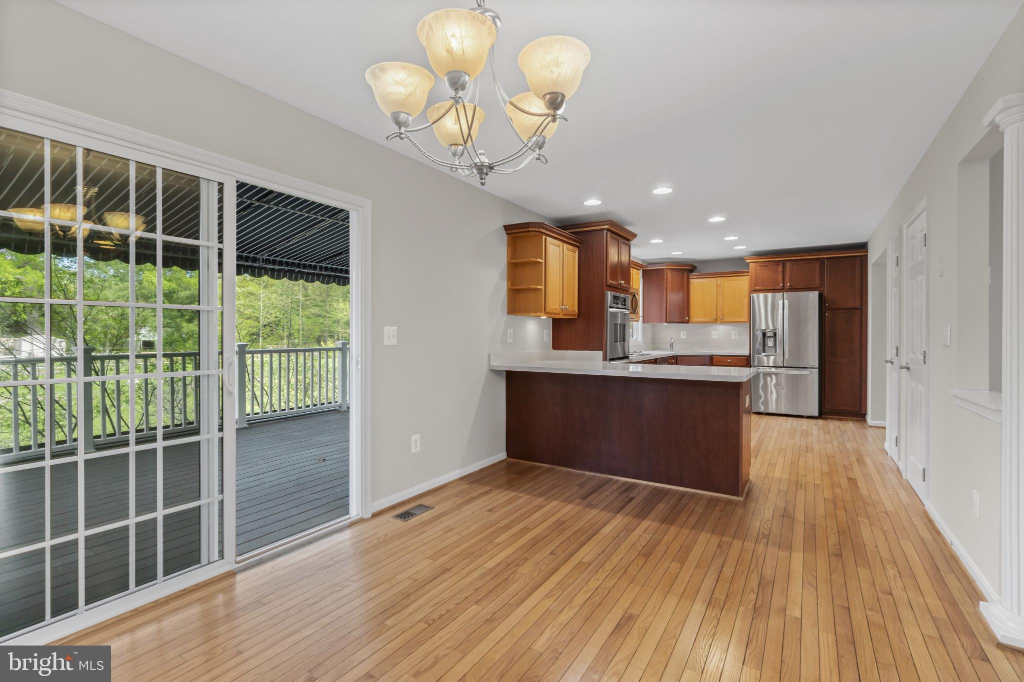 1609 Turkey Point Road Essex, MD 21221 - Photo 14 of 41 a open kitchen with kitchen island granite countertop wooden cabinets and stainless steel appliances
