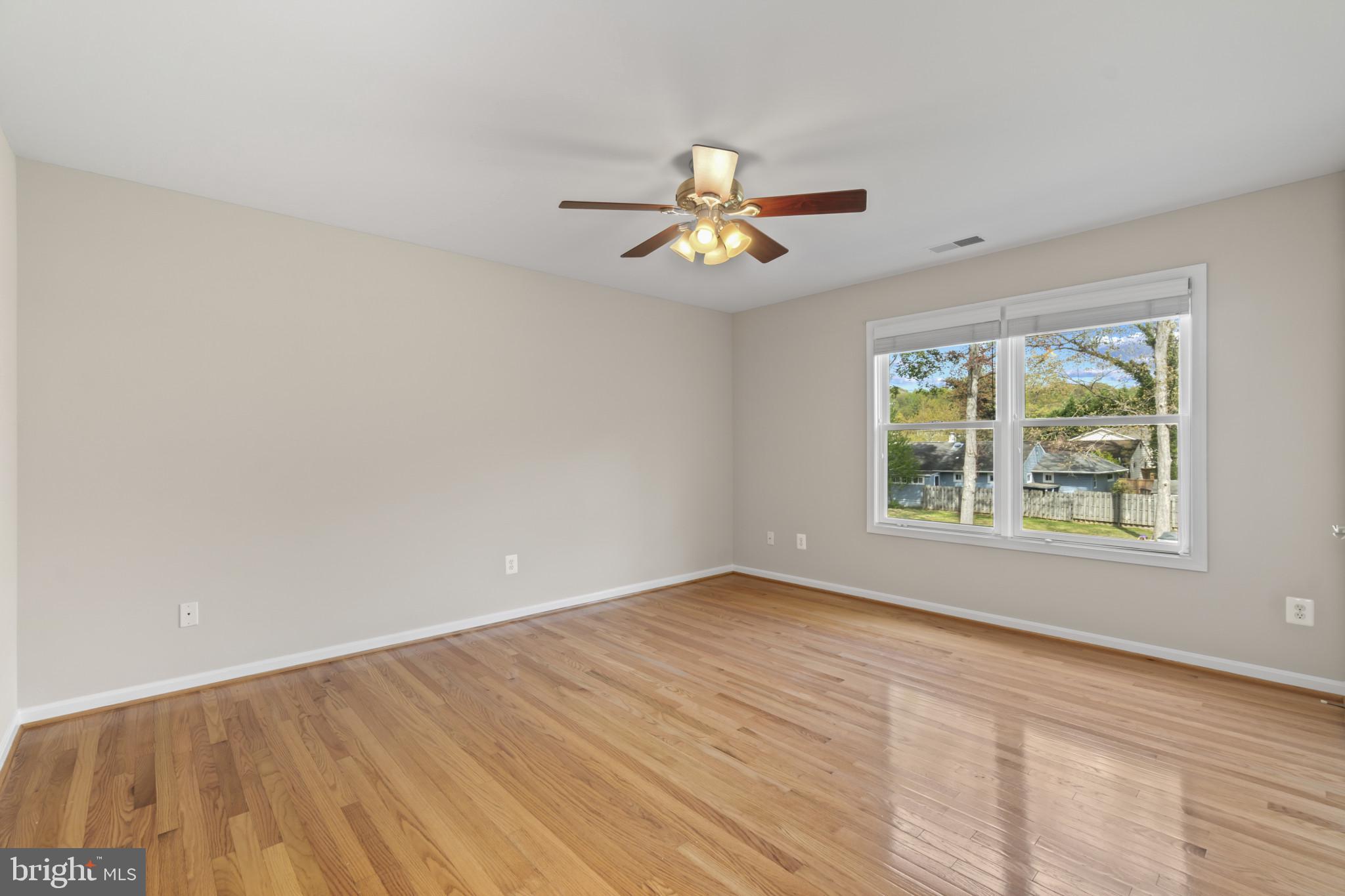 1609 Turkey Point Road Essex, MD 21221 - Photo 16 of 41 wooden floor in an empty room with a window