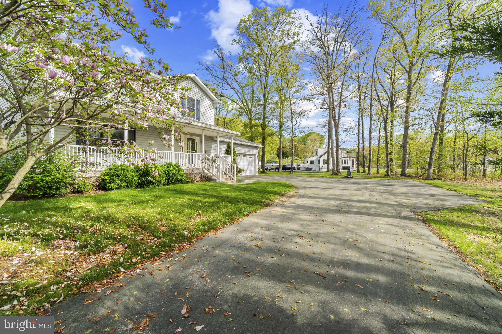 1609 Turkey Point Road Essex, MD 21221 - Photo 2 of 41 a view of white house with a big yard and large trees