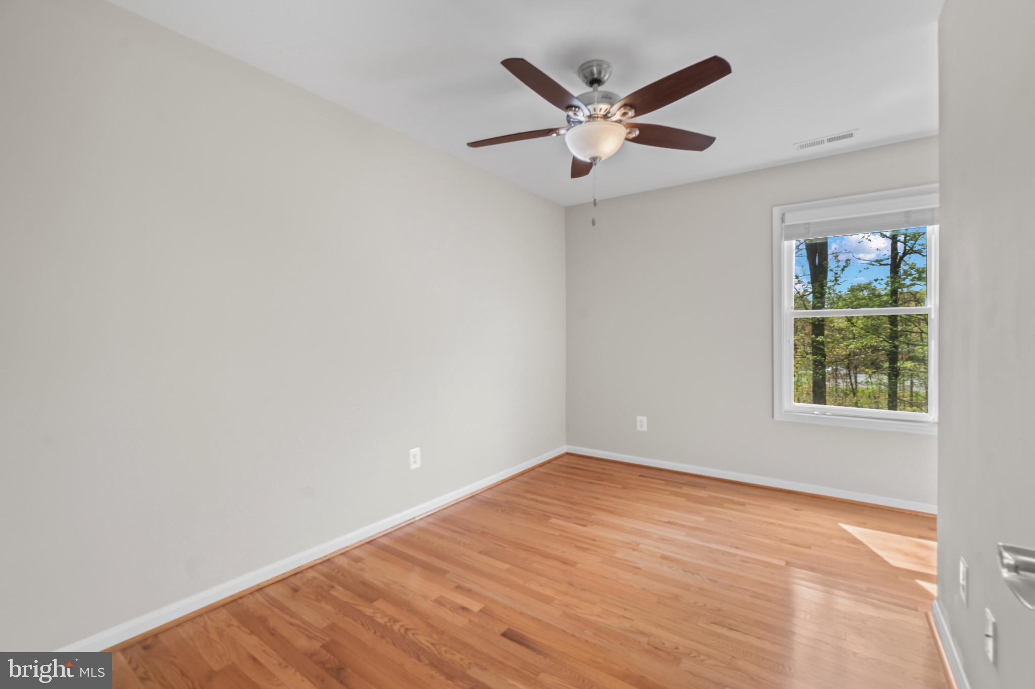 1609 Turkey Point Road Essex, MD 21221 - Photo 24 of 41 an empty room with a window and ceiling fan