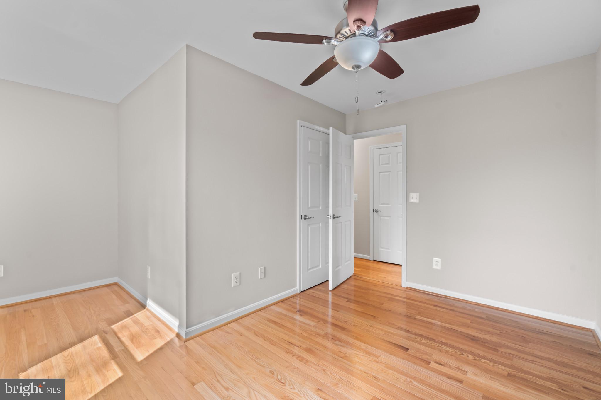1609 Turkey Point Road Essex, MD 21221 - Photo 25 of 41 an empty room with wooden floor chandelier fan and closet in a room