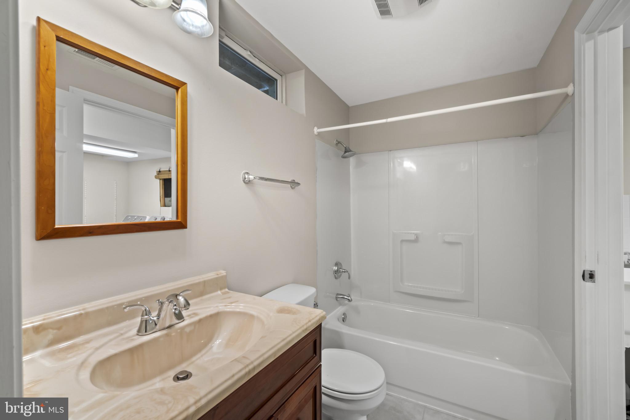 1609 Turkey Point Road Essex, MD 21221 - Photo 33 of 41 a bathroom with a bathtub shower sink vanity and toilet
