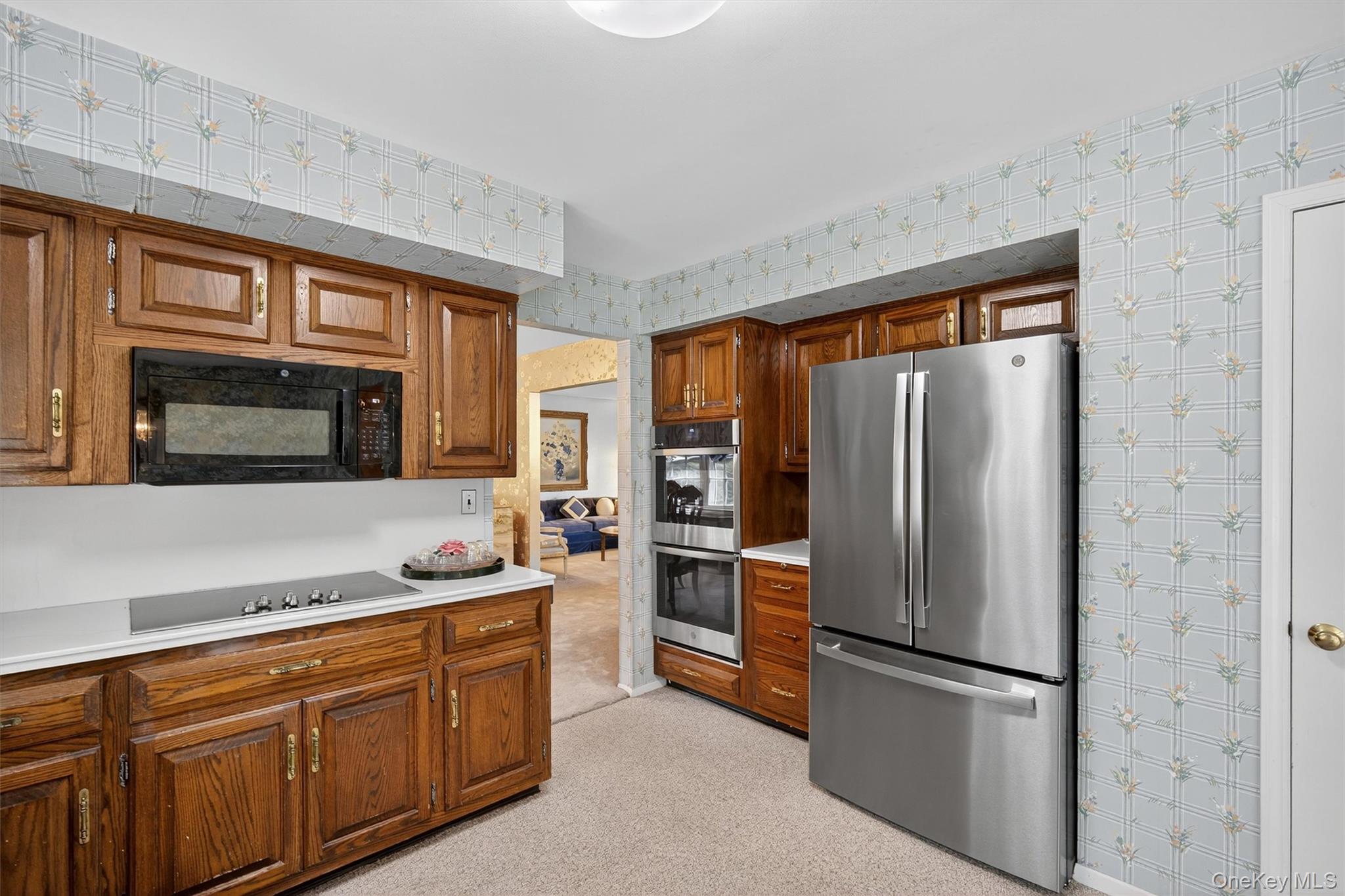 27 Orchard Hill Road Katonah, NY 10536 - Photo 11 of 38 a kitchen with stainless steel appliances granite countertop a refrigerator and a stove top oven