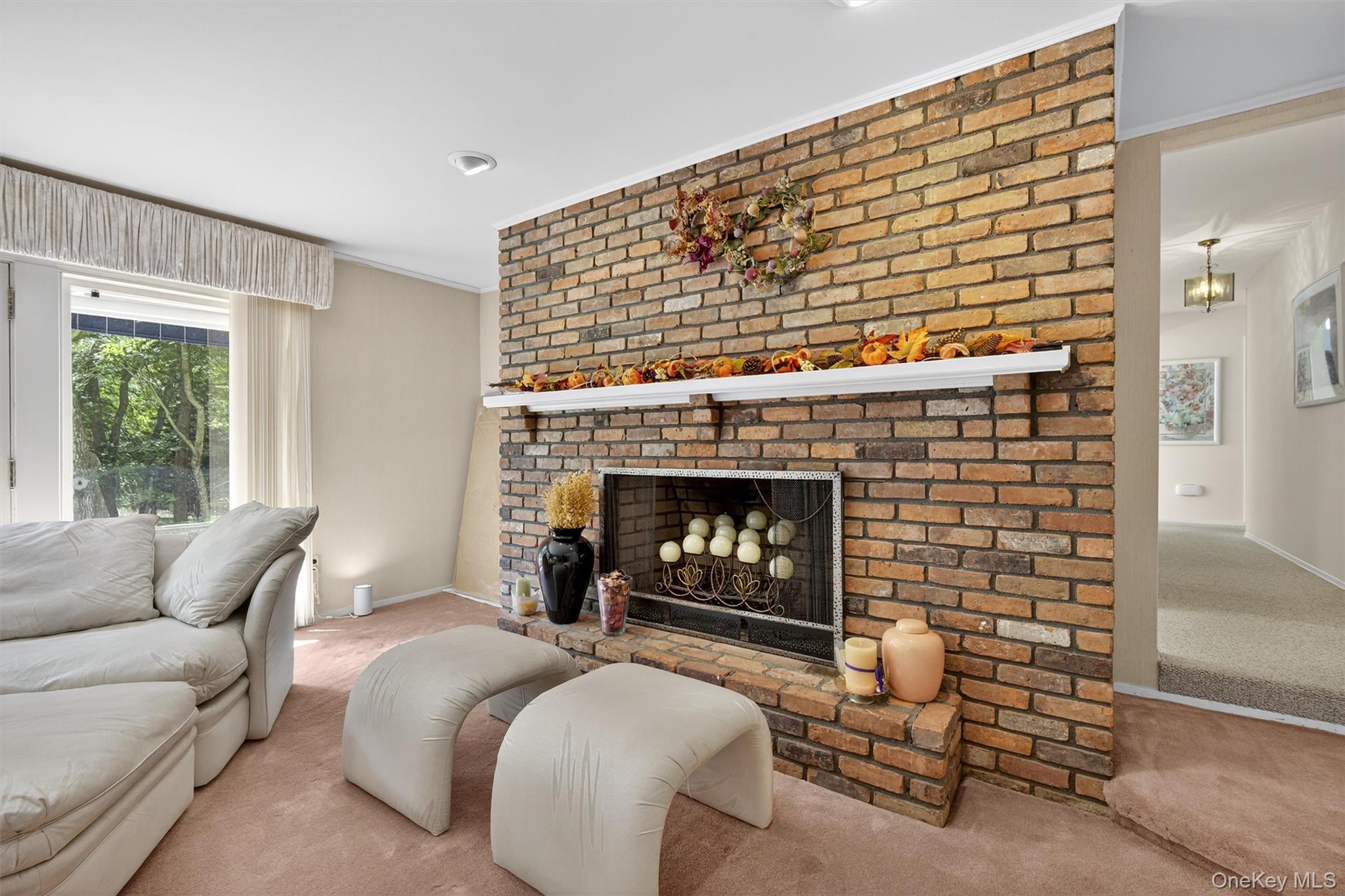 27 Orchard Hill Road Katonah, NY 10536 - Photo 18 of 38 a living room with furniture and a fireplace