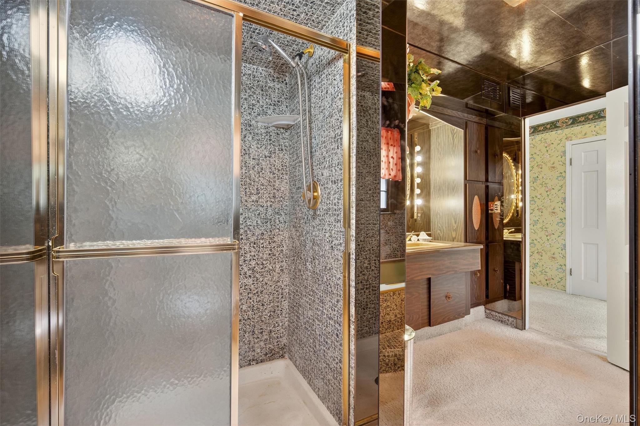 27 Orchard Hill Road Katonah, NY 10536 - Photo 25 of 38 a bathroom with a glass shower door