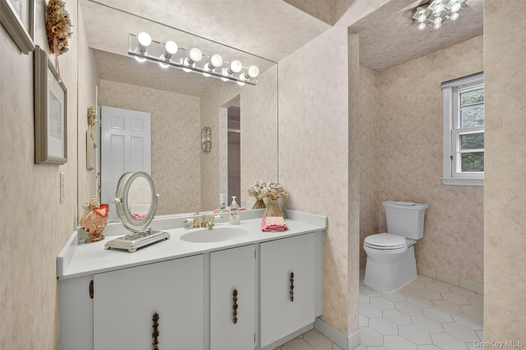 27 Orchard Hill Road Katonah, NY 10536 - Photo 29 of 38 a bathroom with a double vanity sink and a mirror