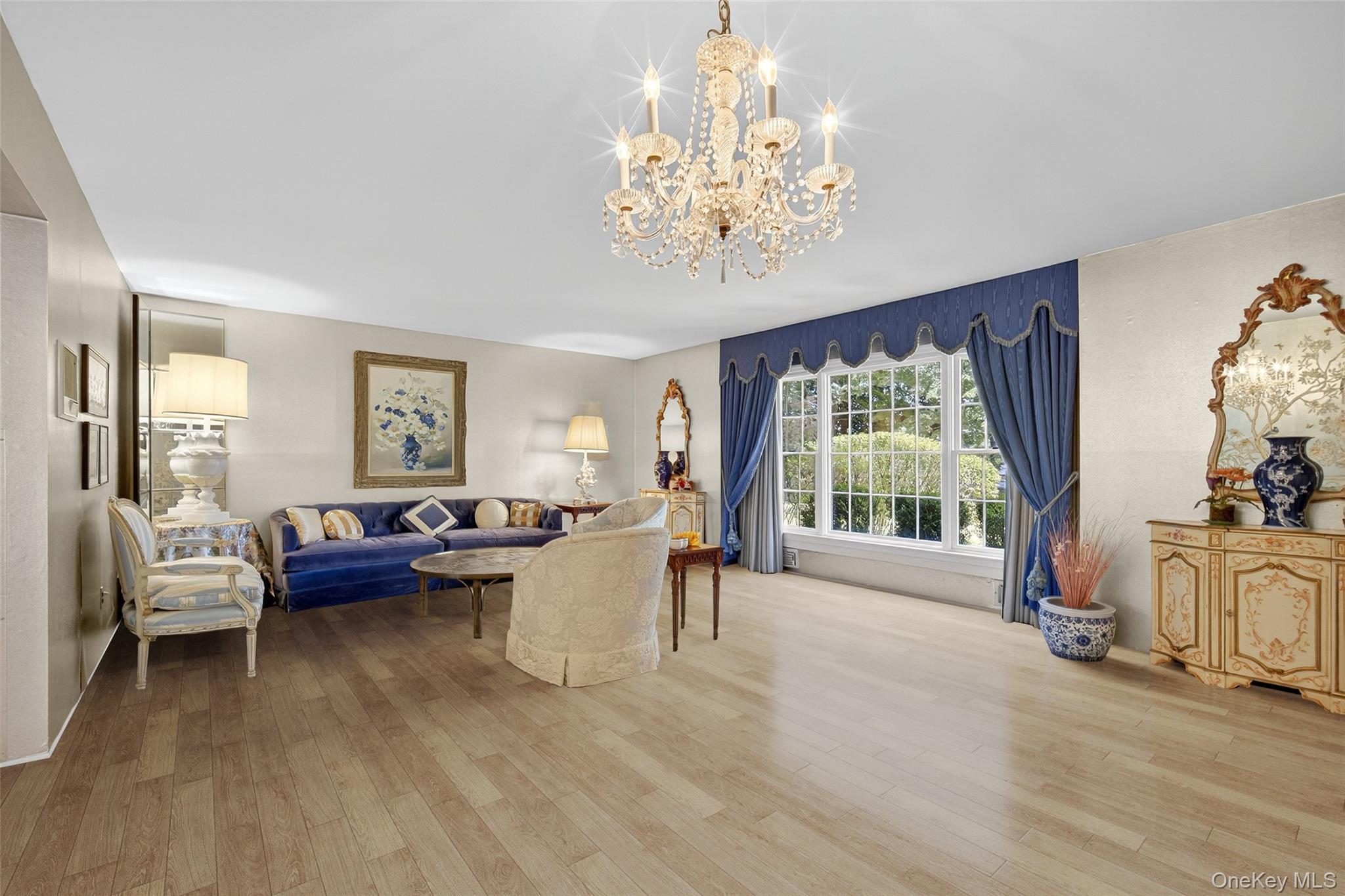 27 Orchard Hill Road Katonah, NY 10536 - Photo 4 of 38 a living room with furniture and a chandelier