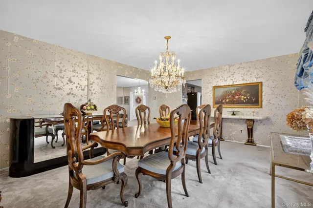 a view of a dining room with furniture and chandelier