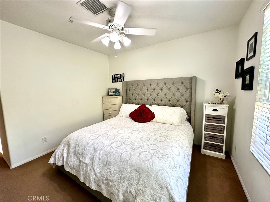 12 Martino Ladera Ranch, CA 92694 - Photo 12 of 17 a bedroom with a bed and a chandelier