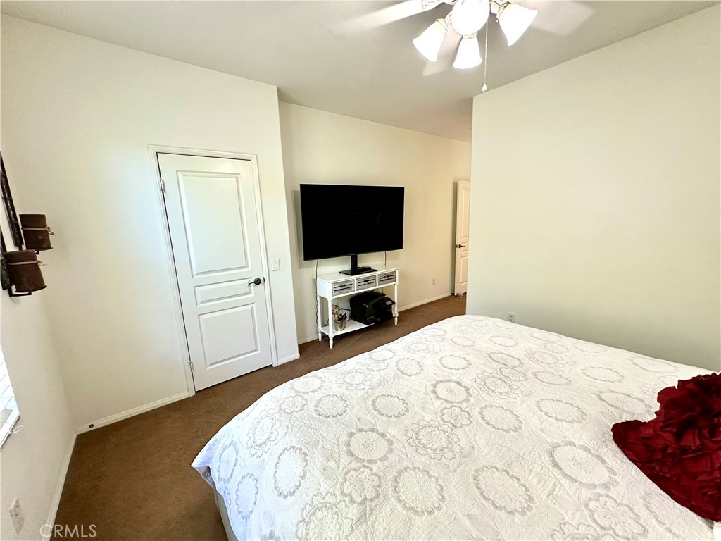12 Martino Ladera Ranch, CA 92694 - Photo 13 of 17 a bedroom with a bed and a flat tv screen on dresser