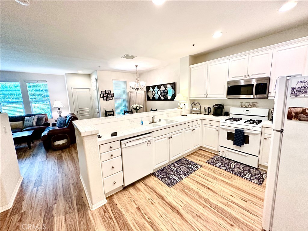 12 Martino Ladera Ranch, CA 92694 - Photo 5 of 17 a kitchen with stainless steel appliances a stove a sink a microwave a refrigerator and cabinets