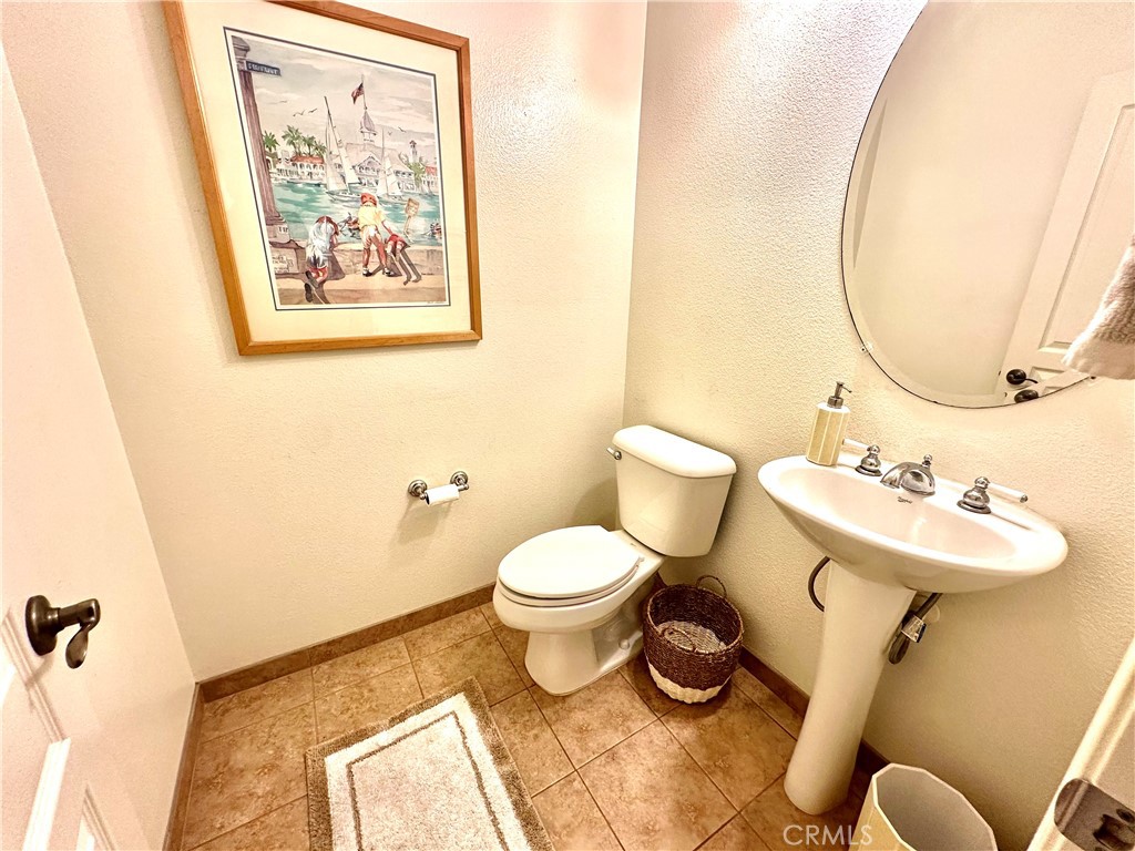 12 Martino Ladera Ranch, CA 92694 - Photo 6 of 17 a bathroom with a toilet sink and mirror