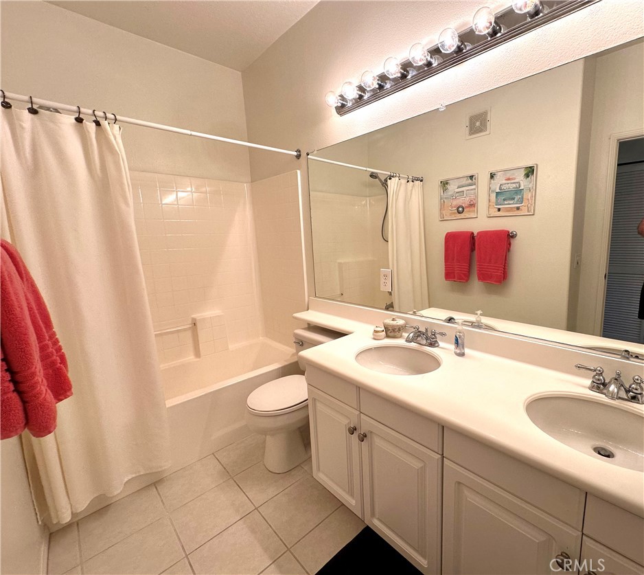 12 Martino Ladera Ranch, CA 92694 - Photo 8 of 17 a bathroom with a sink a toilet a mirror a vanity and shower