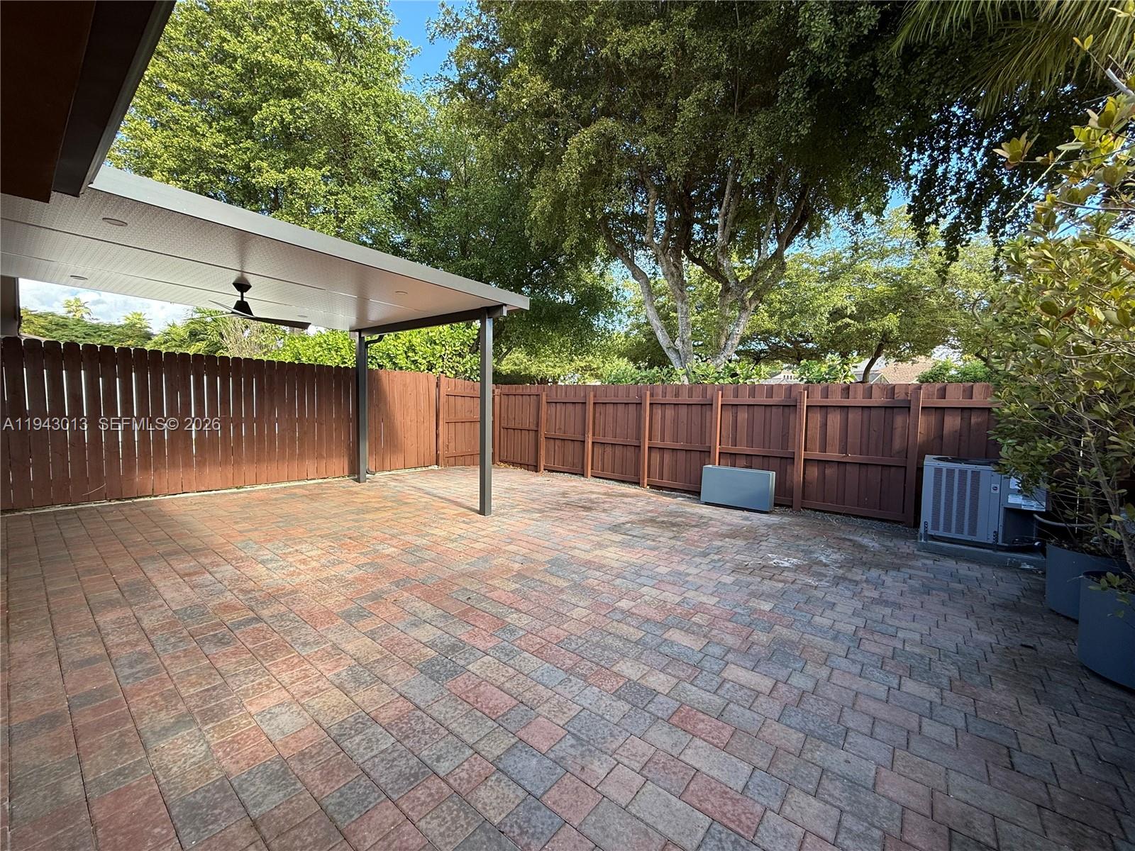 9208 Southwest 132nd Street Miami, FL 33176 - Photo 18 of 24 a view of a backyard with a shade house and large tree