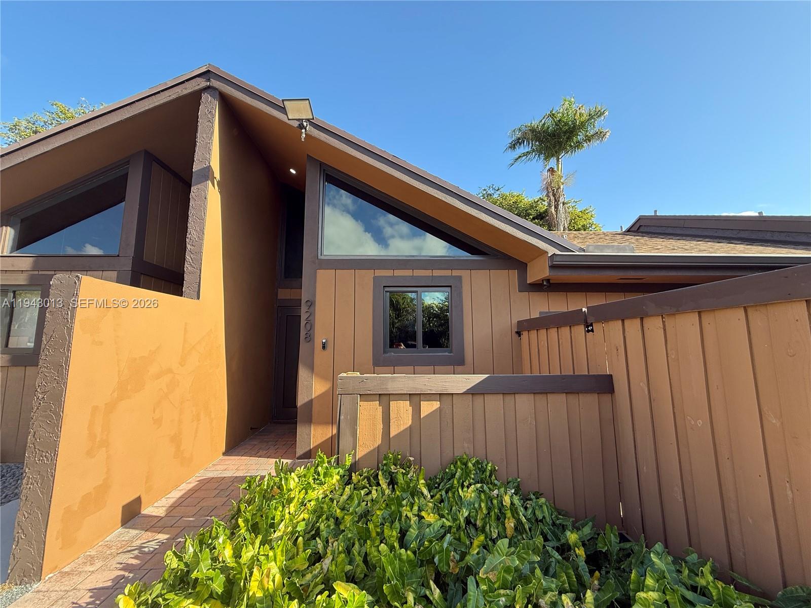 9208 Southwest 132nd Street Miami, FL 33176 - Photo 22 of 24 a front view of a house with a yard