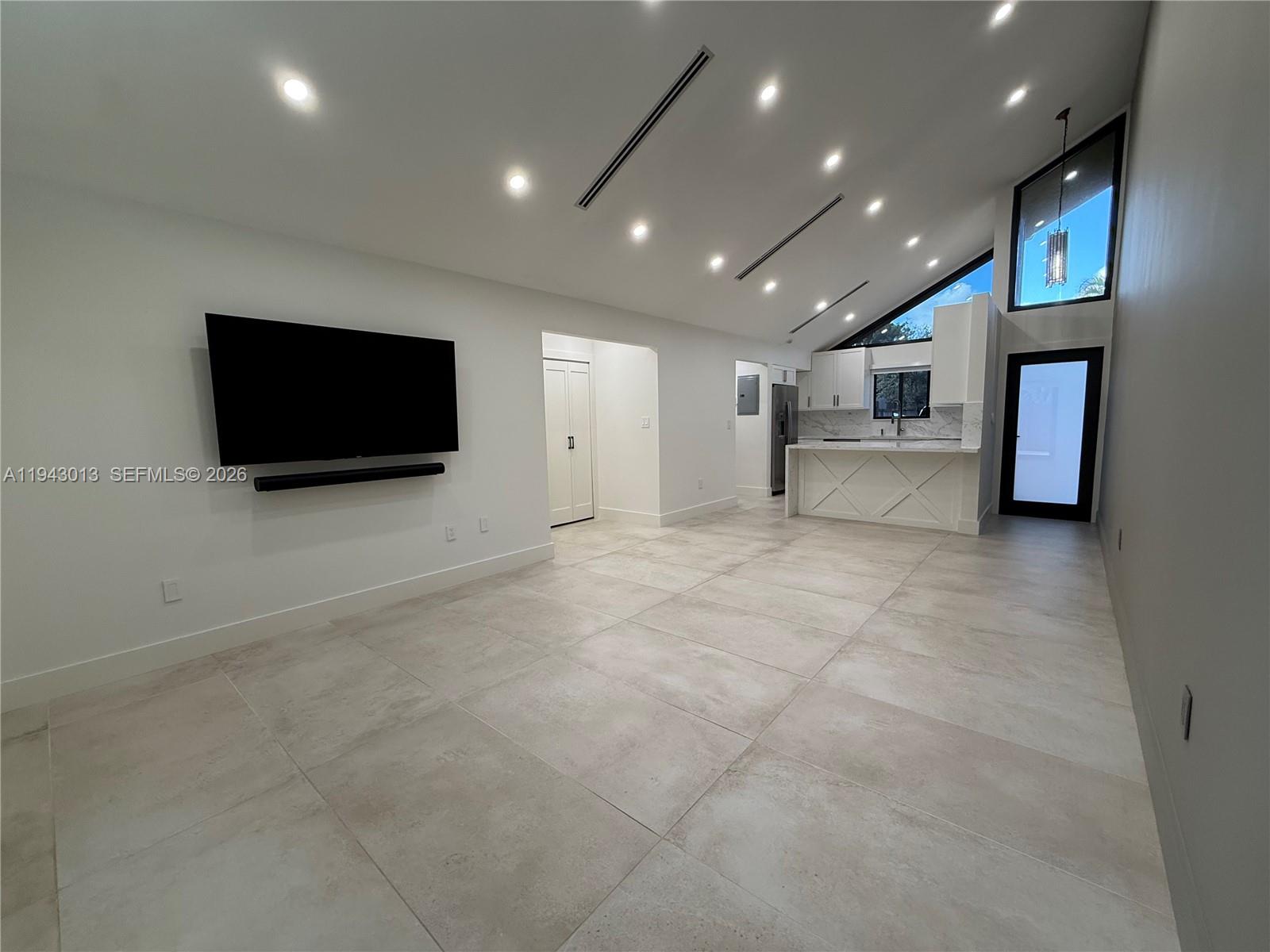 9208 Southwest 132nd Street Miami, FL 33176 - Photo 3 of 24 a view of a livingroom with furniture and a flat screen tv