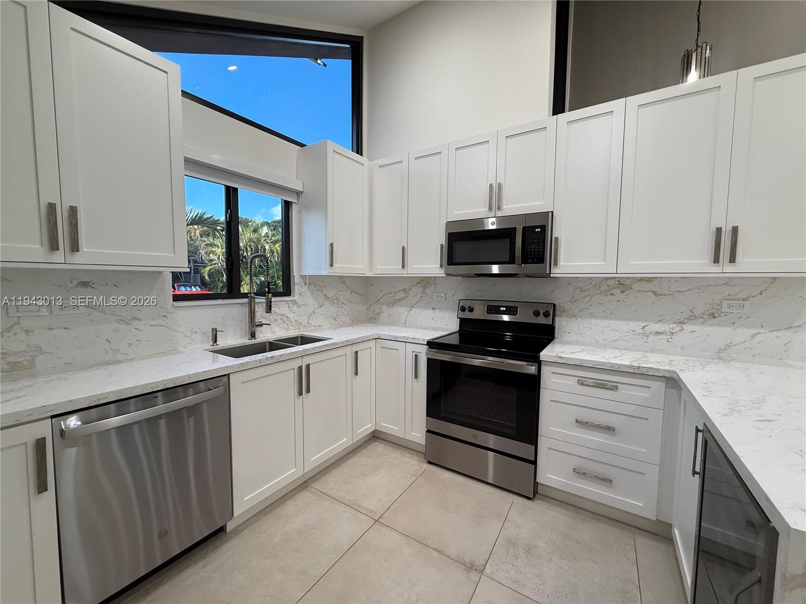 9208 Southwest 132nd Street Miami, FL 33176 - Photo 5 of 24 a kitchen with stainless steel appliances granite countertop a sink and a stove