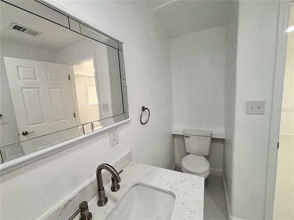 124 Coronado Road, Unit B DeBary, FL 32713 - Photo 11 of 18 a bathroom with a sink and a mirror