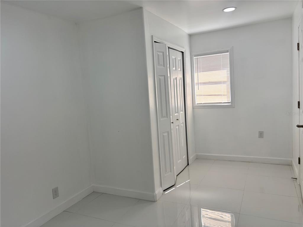 124 Coronado Road, Unit B DeBary, FL 32713 - Photo 5 of 18 an empty room with windows